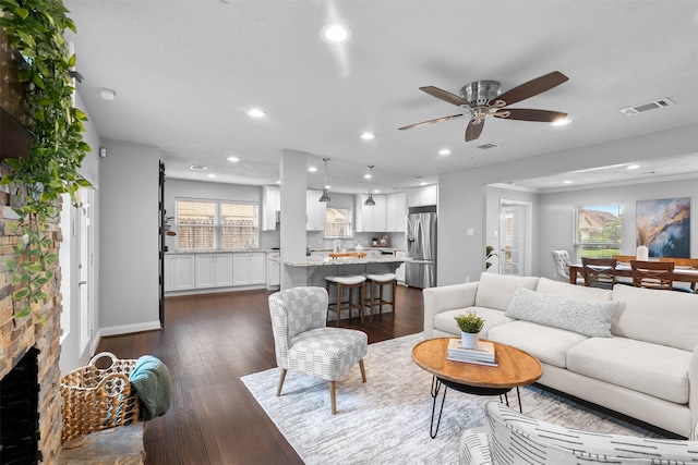 1139 Lehman St, Houston, TX 77018 - living room featuring a ceiling fan, recessed lighting, dark wood finished floors, and baseboards