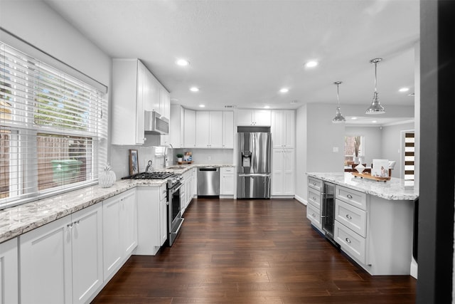 1139 Lehman St, Houston, TX 77018 - kitchen featuring appliances with stainless steel finishes, beverage cooler, recessed lighting, white cabinetry, and dark wood finished floors