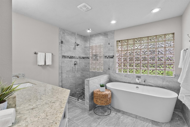 1139 Lehman St, Houston, TX 77018 - bathroom featuring a soaking tub, a stall shower, double vanity, recessed lighting, and marble look tile flooring