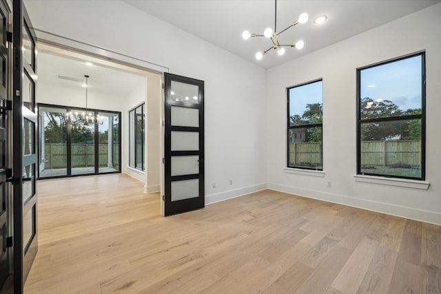 1112 Kinley Ln, Houston, TX 77018 - unfurnished room featuring a chandelier and light wood-type flooring