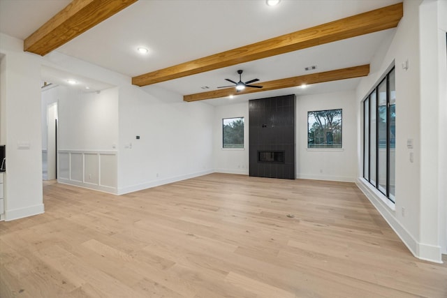 1112 Kinley Ln, Houston, TX 77018 - unfurnished living room featuring ceiling fan, light wood-style flooring, recessed lighting, beam ceiling, and a fireplace