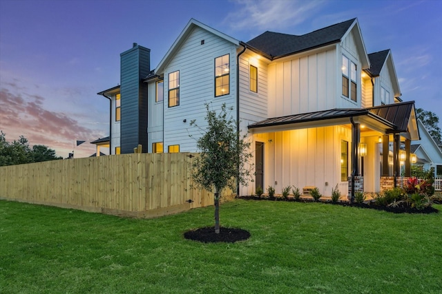 1112 Kinley Ln, Houston, TX 77018 - view of front of property featuring board and batten siding, a standing seam roof, a chimney, and a metal roof