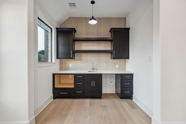1112 Kinley Ln, Houston, TX 77018 - kitchen with open shelves, light wood-style flooring, light countertops, decorative backsplash, and pendant lighting