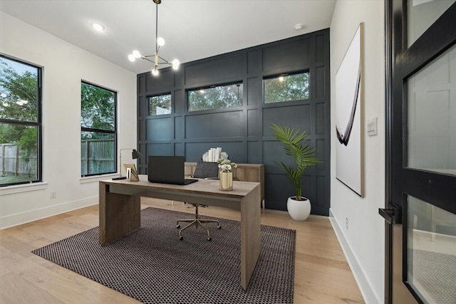 1112 Kinley Ln, Houston, TX 77018 - home office featuring light wood finished floors, a decorative wall, and a chandelier