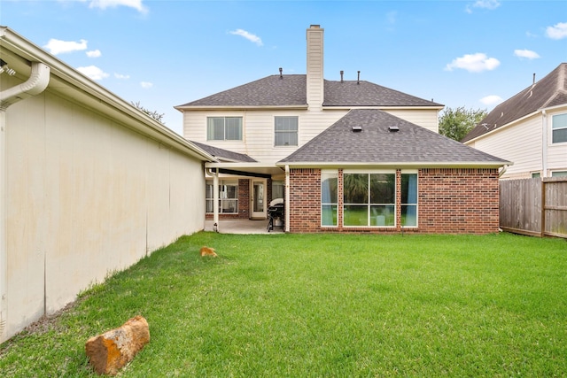 1706 Brightlake Way, Missouri City, TX 77459 - rear view of house featuring roof with shingles, a patio area, brick siding, and a chimney