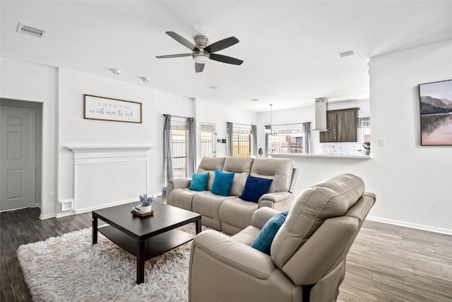 1706 Brightlake Way, Missouri City, TX 77459 - living area featuring a ceiling fan, baseboards, and wood finished floors