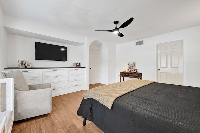 15427 Stonehill Dr, Houston, TX 77062 - bedroom featuring arched walkways, light wood-style flooring, and a ceiling fan