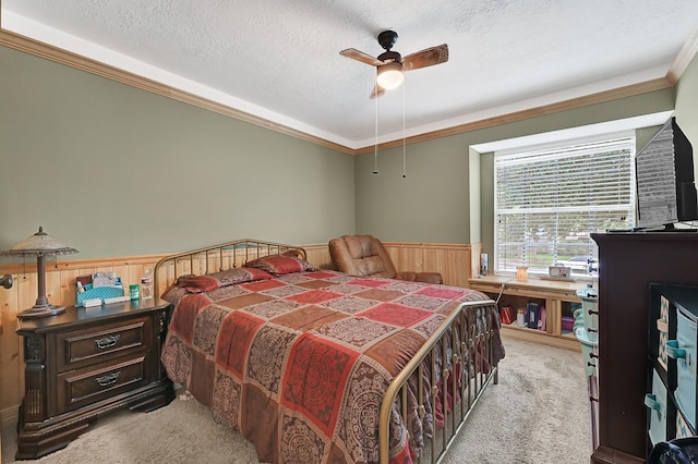 15427 Stonehill Dr, Houston, TX 77062 - bedroom featuring light colored carpet, crown molding, wainscoting, a textured ceiling, and a ceiling fan