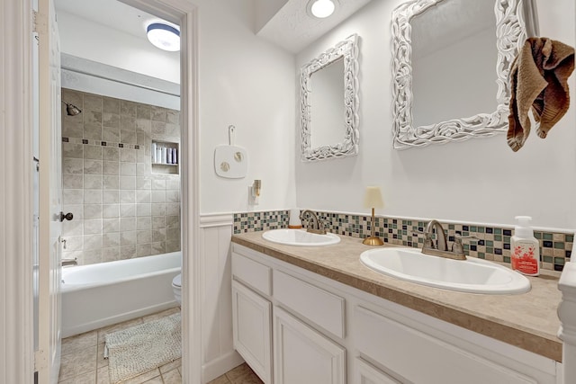 15427 Stonehill Dr, Houston, TX 77062 - full bath with double vanity, toilet, tub / shower combination, tile patterned floors, and tasteful backsplash