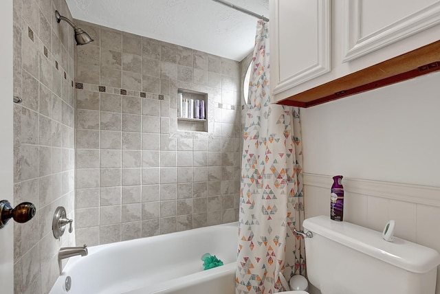 15427 Stonehill Dr, Houston, TX 77062 - full bathroom featuring shower / bath combination with curtain, toilet, and a wainscoted wall