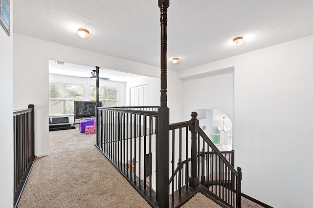 15427 Stonehill Dr, Houston, TX 77062 - corridor with an upstairs landing, carpet floors, baseboards, and arched walkways
