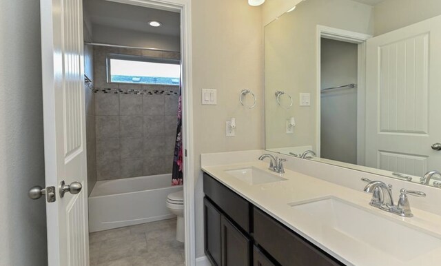 5422 Wildbrush Dr, Richmond, TX 77407 - bathroom with toilet, double vanity, shower / bath combo with shower curtain, and tile patterned flooring