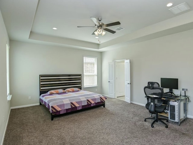 5422 Wildbrush Dr, Richmond, TX 77407 - carpeted bedroom featuring a tray ceiling, baseboards, recessed lighting, and a desk