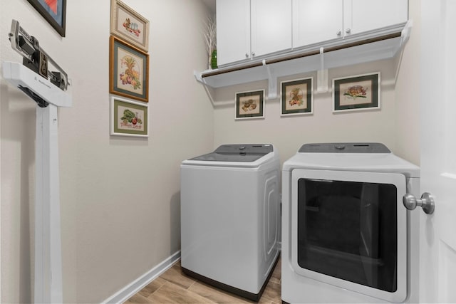 371 Westlake Terrace Dr, Conroe, TX 77304 - washroom with cabinet space, independent washer and dryer, light wood-style floors, and baseboards