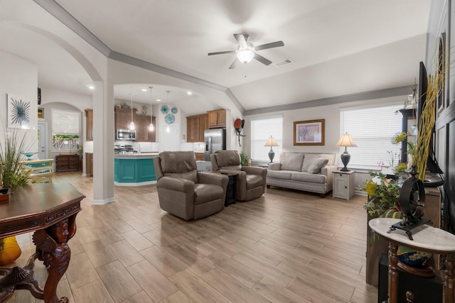 371 Westlake Terrace Dr, Conroe, TX 77304 - living room with arched walkways, ceiling fan, vaulted ceiling, and light wood finished floors