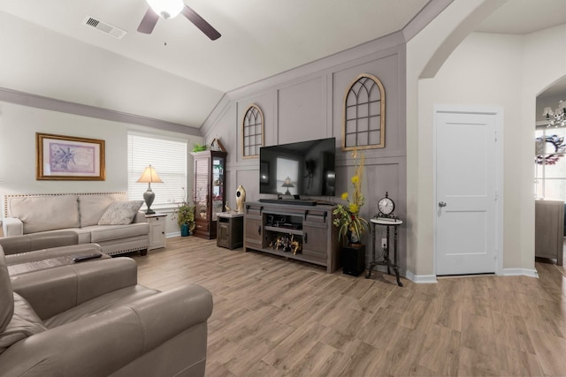 371 Westlake Terrace Dr, Conroe, TX 77304 - living area featuring lofted ceiling, a ceiling fan, arched walkways, light wood finished floors, and a decorative wall