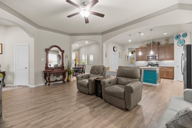 371 Westlake Terrace Dr, Conroe, TX 77304 - living area with arched walkways, a ceiling fan, light wood finished floors, baseboards, and recessed lighting