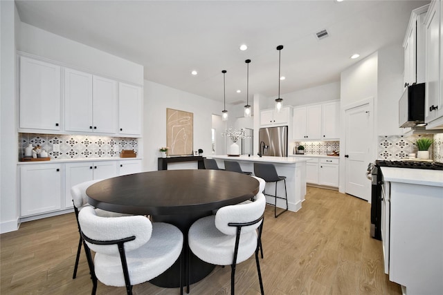 296 N Cascade Heights Dr, Montgomery, TX 77316 - dining area featuring light wood-style floors and recessed lighting