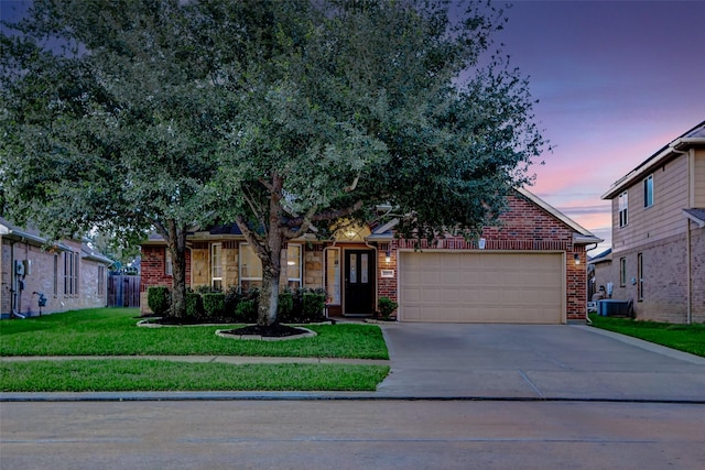 10018 Cedar Creek Ct, Brookshire, TX 77423 - view of property hidden behind natural elements with brick siding, a garage, a front yard, driveway, and central AC unit