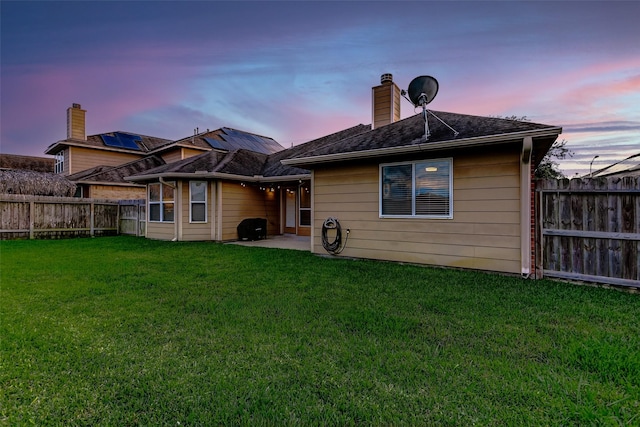 10018 Cedar Creek Ct, Brookshire, TX 77423 - back of house at dusk featuring a patio area and a chimney