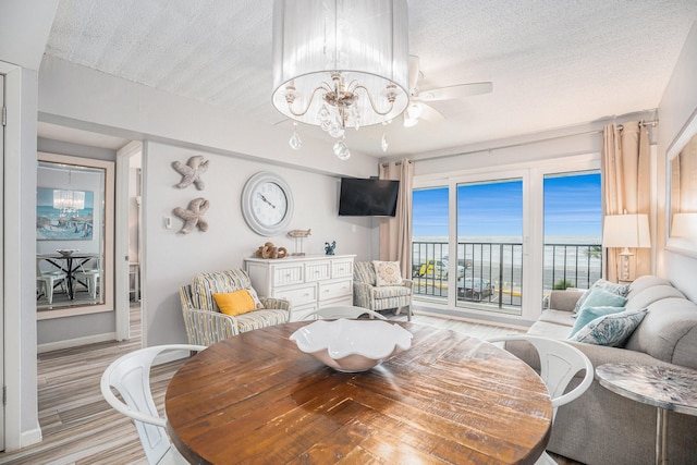 7310 Seawall Blvd Unit 210, Galveston, TX 77551 - living area with a chandelier, light wood-type flooring, and baseboards
