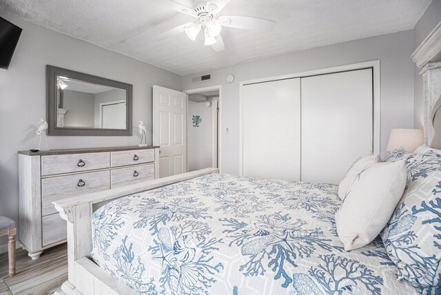 7310 Seawall Blvd Unit 210, Galveston, TX 77551 - bedroom featuring a closet, ceiling fan, and light wood-type flooring