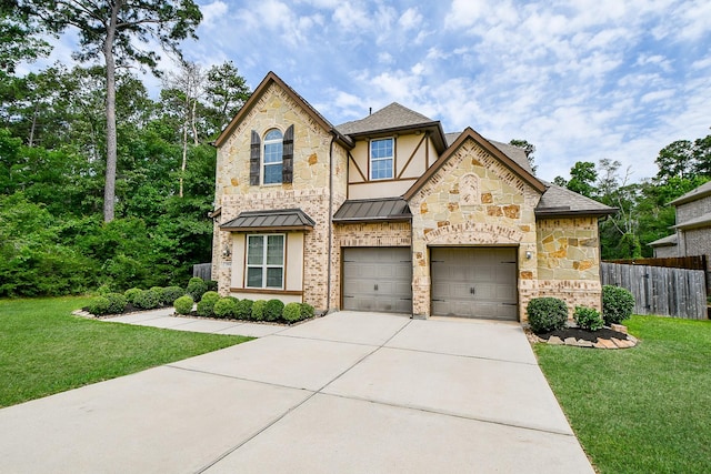 1704 Graystone Hills Dr, Conroe, TX 77304 - view of front of home with concrete driveway, stone siding, a standing seam roof, a shingled roof, and a garage