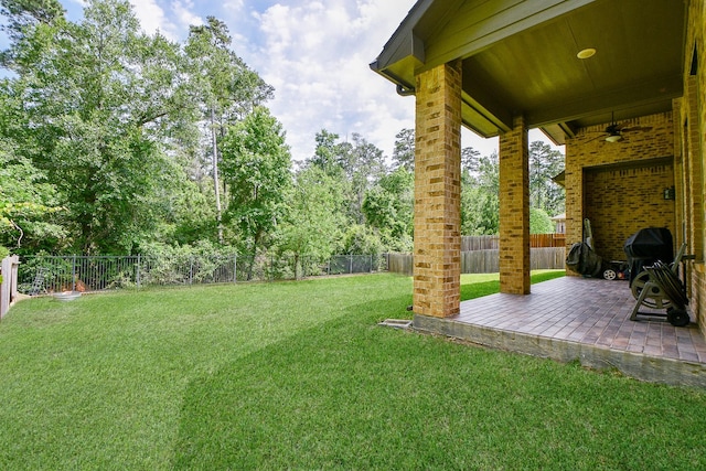 1704 Graystone Hills Dr, Conroe, TX 77304 - view of yard with ceiling fan, a patio, and view of scattered trees