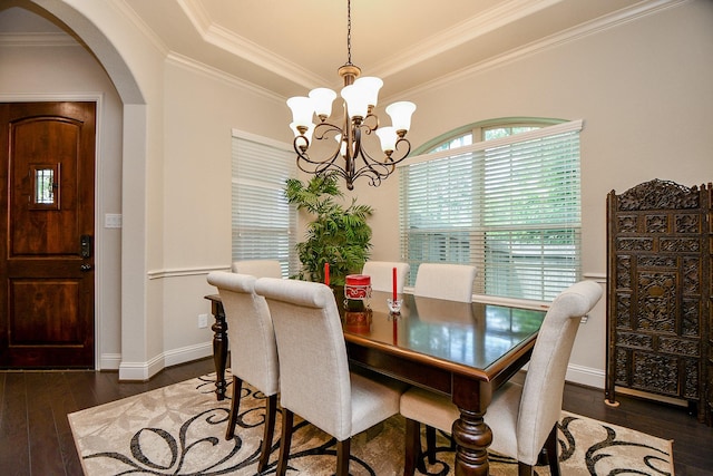 1704 Graystone Hills Dr, Conroe, TX 77304 - dining room with arched walkways, dark wood-type flooring, a chandelier, ornamental molding, and a raised ceiling