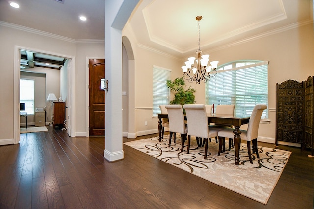 1704 Graystone Hills Dr, Conroe, TX 77304 - dining area with arched walkways, dark wood-style flooring, crown molding, a chandelier, and baseboards