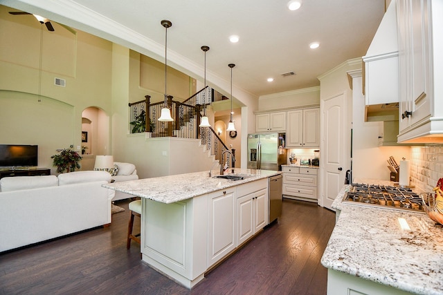 1704 Graystone Hills Dr, Conroe, TX 77304 - kitchen featuring appliances with stainless steel finishes, a sink, crown molding, backsplash, and a ceiling fan