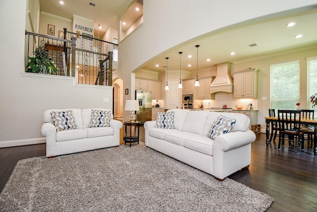 1704 Graystone Hills Dr, Conroe, TX 77304 - living area with arched walkways, crown molding, dark wood-style flooring, recessed lighting, and baseboards