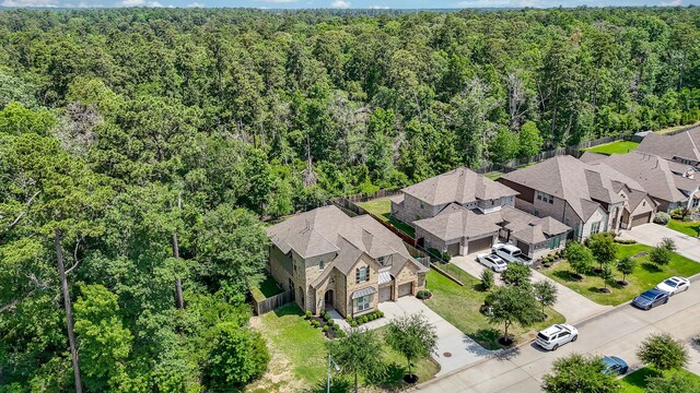 1704 Graystone Hills Dr, Conroe, TX 77304 - aerial perspective of suburban area with a heavily wooded area