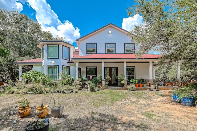 6121 County Road 225, Hungerford, TX 77448 - view of front of house featuring stucco siding, a porch, and roof with shingles