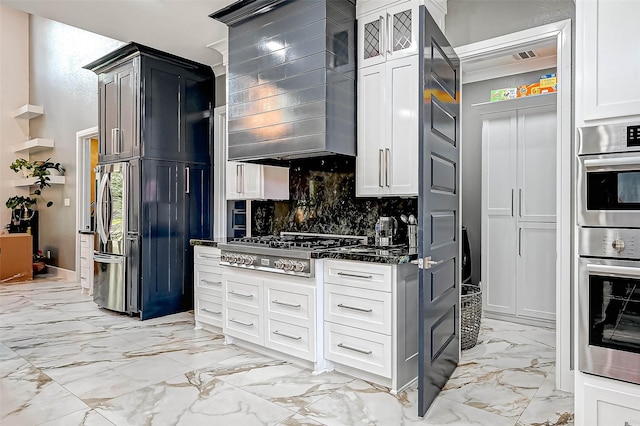 6121 County Road 225, Hungerford, TX 77448 - kitchen with light marble finish floors, stainless steel appliances, tasteful backsplash, dark stone countertops, and wall chimney exhaust hood