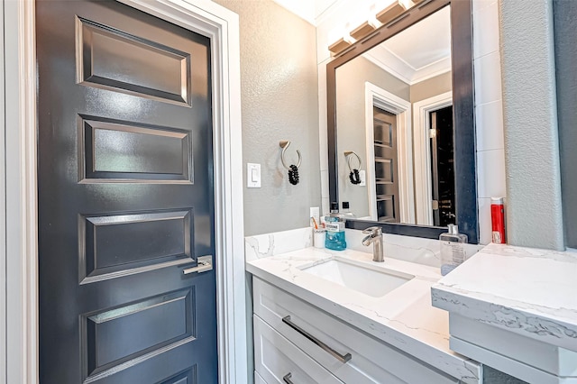 6121 County Road 225, Hungerford, TX 77448 - bathroom featuring vanity, a textured wall, and crown molding
