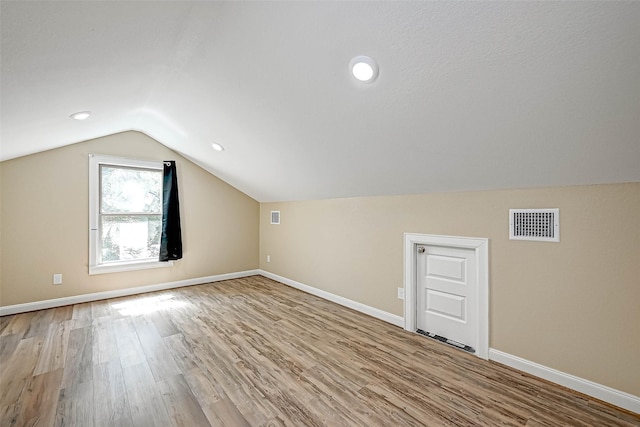 6121 County Road 225, Hungerford, TX 77448 - additional living space featuring vaulted ceiling, wood finished floors, and baseboards