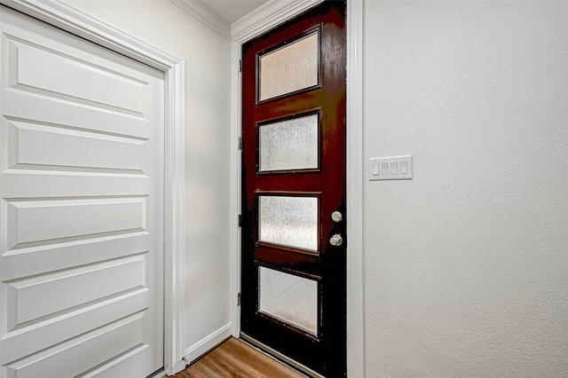 6121 County Road 225, Hungerford, TX 77448 - entrance foyer with crown molding, wood finished floors, and a textured wall