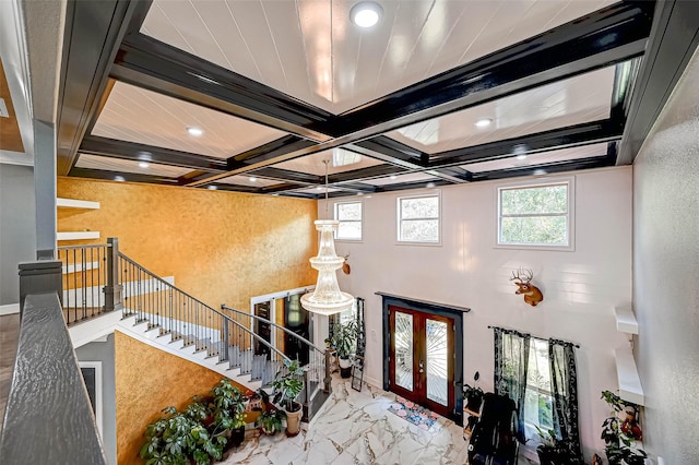 6121 County Road 225, Hungerford, TX 77448 - entrance foyer featuring coffered ceiling, beam ceiling, recessed lighting, french doors, and marble finish floors