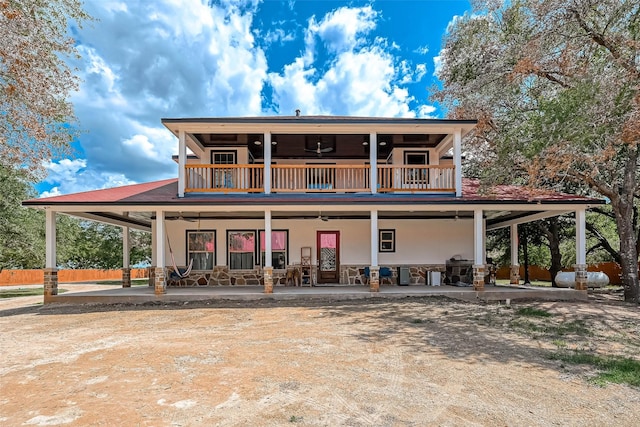 6121 County Road 225, Hungerford, TX 77448 - view of front of home featuring a balcony, a ceiling fan, and a patio area