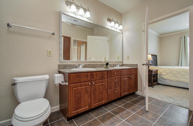 1711 Old Spanish Trl Unit 401, Houston, TX 77054 - ensuite bathroom featuring double vanity, tile patterned flooring, crown molding, toilet, and baseboards