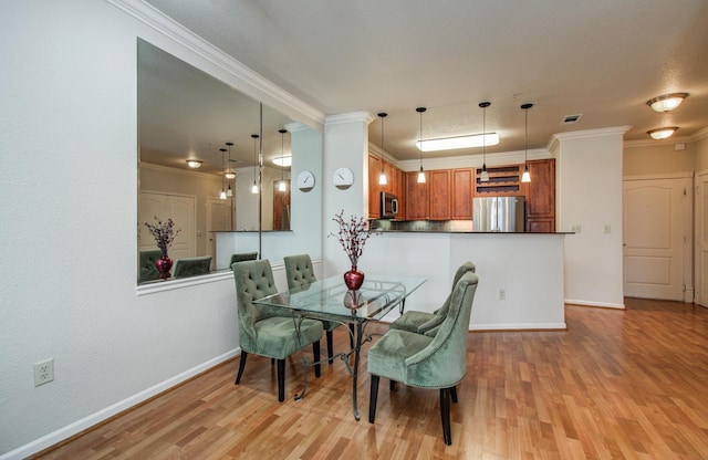 1711 Old Spanish Trl Unit 401, Houston, TX 77054 - dining space featuring light wood-style floors, ornamental molding, and baseboards