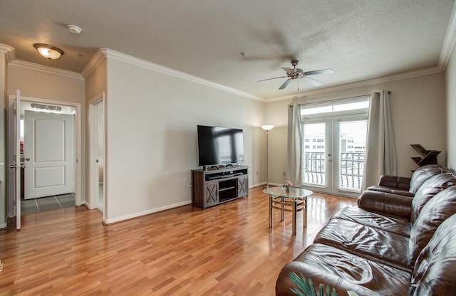 1711 Old Spanish Trl Unit 401, Houston, TX 77054 - living area with light wood-style floors, a ceiling fan, french doors, a textured ceiling, and ornamental molding
