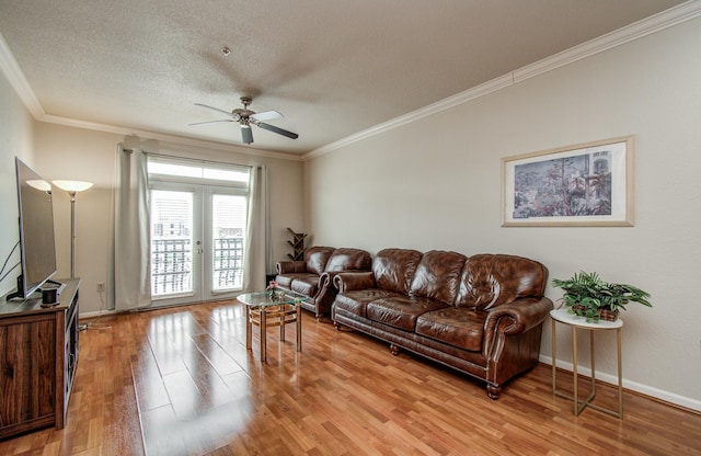 1711 Old Spanish Trl Unit 401, Houston, TX 77054 - living area with crown molding, light wood-style floors, a ceiling fan, french doors, and a textured ceiling