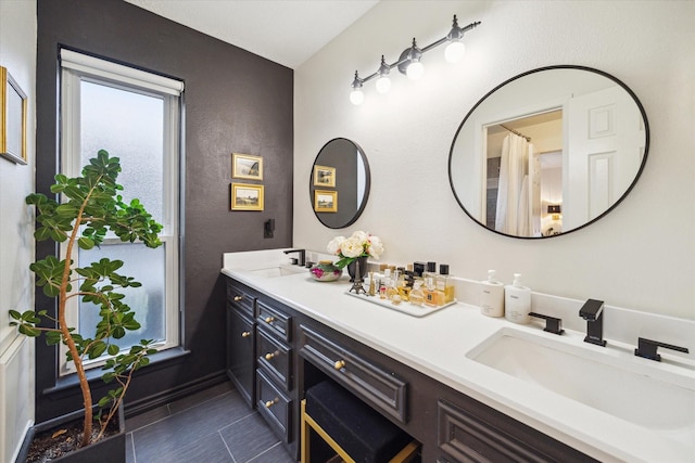 2227 Holly Knoll St, Houston, TX 77077 - bathroom featuring double vanity, tile patterned flooring, and a textured wall