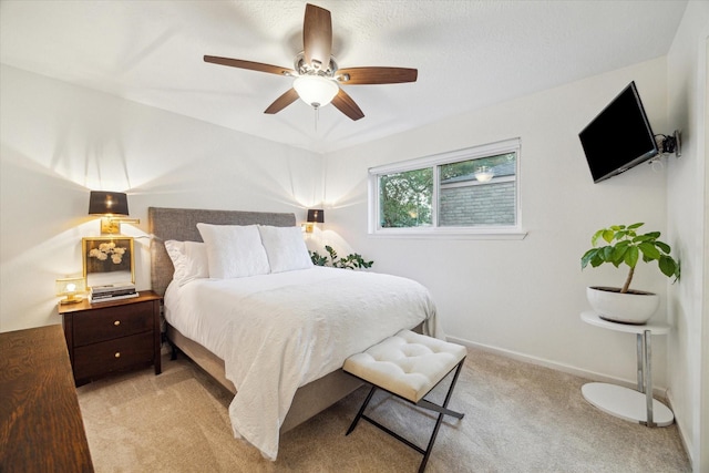 2227 Holly Knoll St, Houston, TX 77077 - bedroom with light carpet, ceiling fan, and baseboards