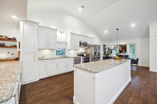 2227 Holly Knoll St, Houston, TX 77077 - kitchen featuring stainless steel appliances, a kitchen island, dark wood-style flooring, vaulted ceiling, and backsplash