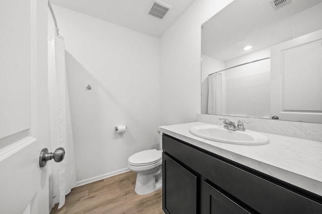 18107 Rockvine Dr, Hockley, TX 77447 - full bathroom featuring vanity, wood finished floors, toilet, baseboards, and a shower with shower curtain