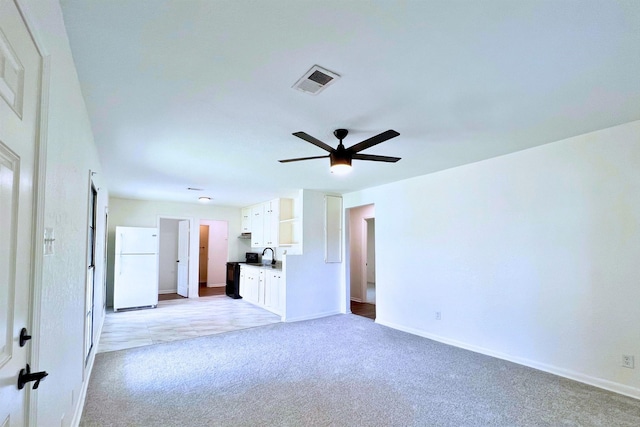 320 Azalea St, Lake Jackson, TX 77566 - unfurnished living room featuring light colored carpet, a ceiling fan, baseboards, and a sink