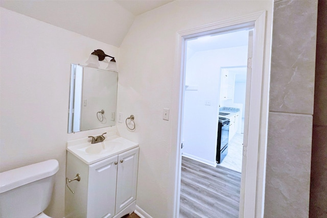 320 Azalea St, Lake Jackson, TX 77566 - half bath with toilet, vanity, lofted ceiling, and wood finished floors